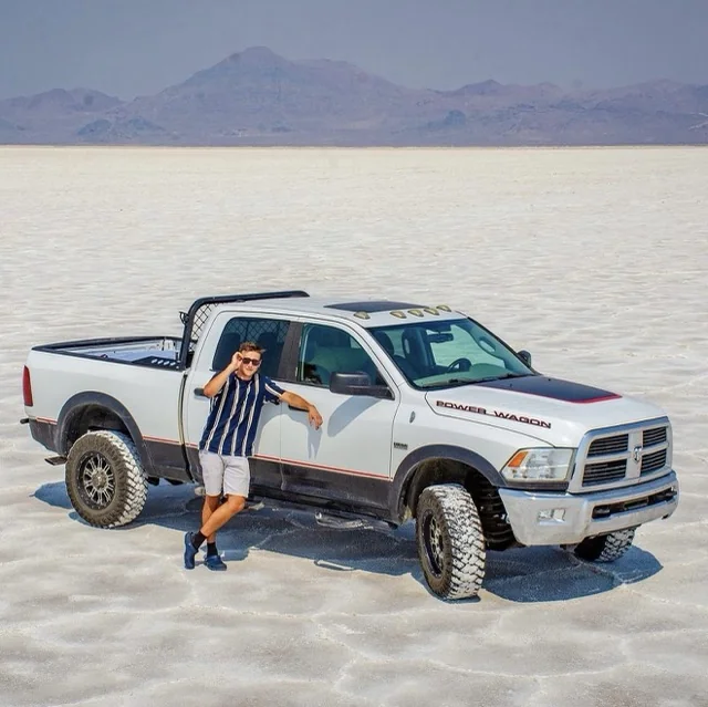 Thomas, Manager at Platinum Wheels and Tires, leaning on a lifted white Dodge Power Wagon on the Bonneville Salt Flats